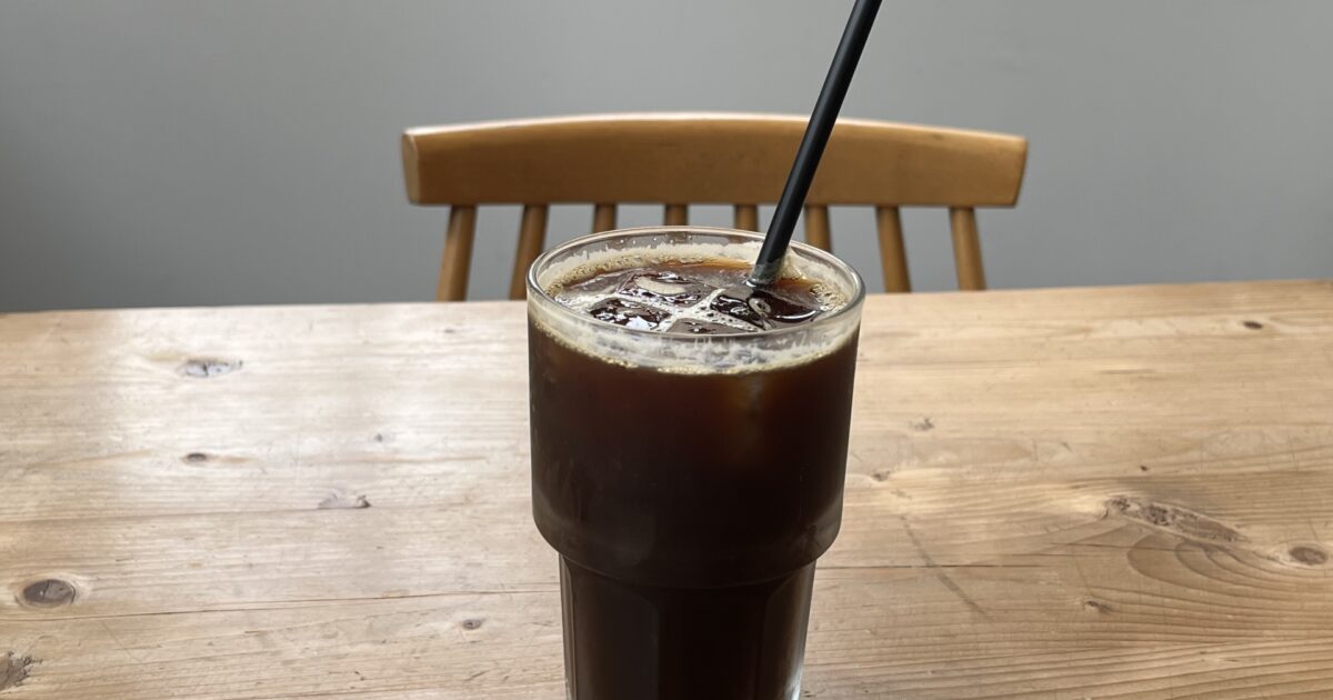 ストロー付きグラスに注がれたアイスコーヒー
